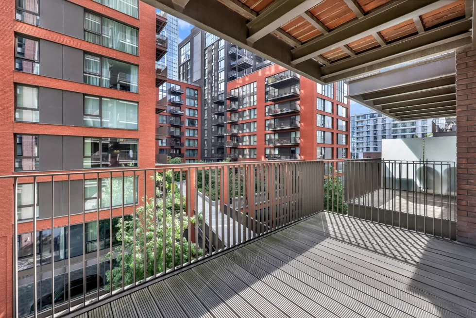 Decked private balcony looking across the courtyard to neighbouring Embassy Gardens blocks