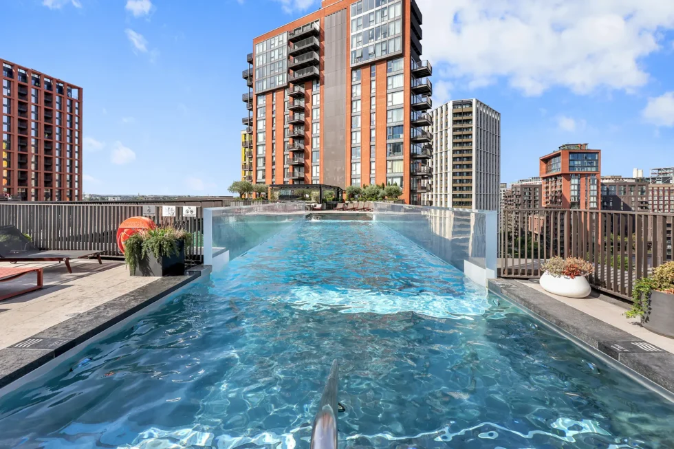 The Sky Pool at Embassy Gardens, Nine Elms, with sun loungers and the surrounding towers