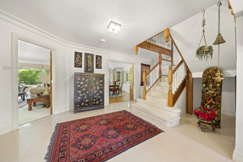 Entrance hall looking towards the staircase, with doors opening to the dining room and living room