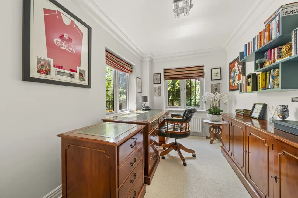 Study with twin pedestal desks, fitted shelving and two garden-facing windows