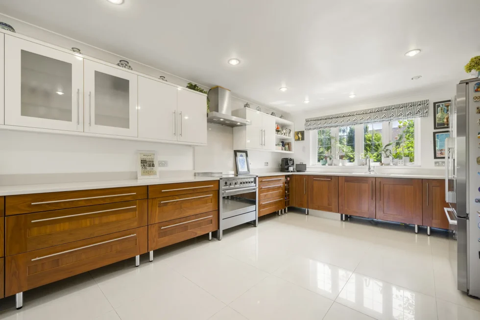 Kitchen with walnut and white cabinetry, quartz worktops and range cooker