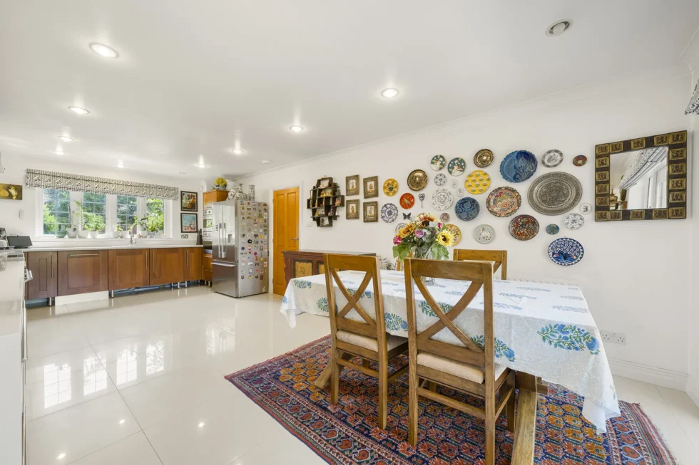 Informal family dining area within the kitchen, with garden window and decorative plate display